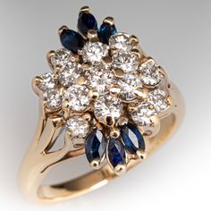 The sophisticated cluster ring is accented with fifteen (15) prong set, round brilliant cut diamonds and six (6) prong set, marquise cut natural sapphires. The ring measures 18.6mm at the top, rises 9.8mm above the finger, tapering to 2.1mm wide and 1.2mm thick at the base of the shank. Several of the diamonds are lightly chipped but nothing that can be seen without magnification. It is currently a size 6. Anniversary Marquise Cut Multi-stone Cluster Ring, Marquise Cut Multi-stone Cluster Ring For Anniversary, Marquise Multi-stone Cluster Ring For Anniversary, Wedding Sapphire Cluster Ring With Diamond Accents, Heirloom Multi-stone Marquise Cut Cluster Ring, Cluster Sapphire Ring For Anniversary, Heirloom Marquise Cut Multi-stone Cluster Ring, Marquise Multi-stone Cluster Ring For Formal Occasions, Formal Marquise Multi-stone Cluster Ring