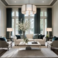 a living room with two couches, chairs and a coffee table in front of large windows