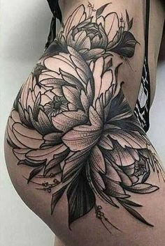 a woman's thigh with flowers on it and the lower part of her stomach