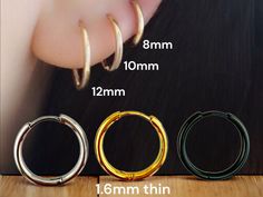 three different types of hoop earrings on a wooden surface with measurements for each pair and how to measure them