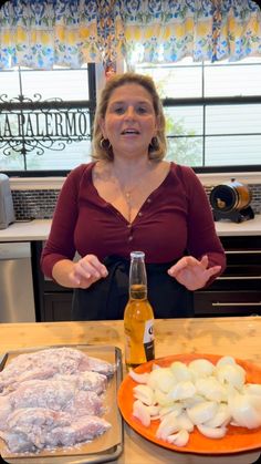 a woman standing in front of a table with food on it