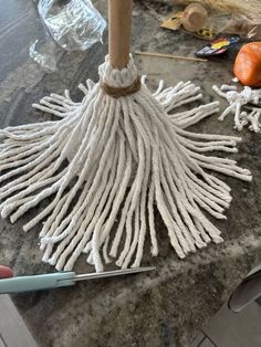 a large white mop sitting on top of a counter next to a pair of scissors