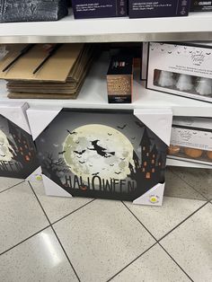 there are three halloween boxes on the shelf