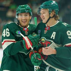 two hockey players standing next to each other