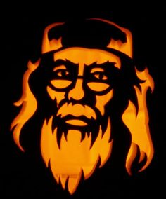 a carved pumpkin with a man's face in the center and flames around it