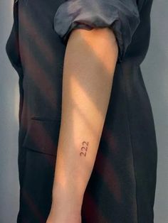 a person with a small tattoo on their arm