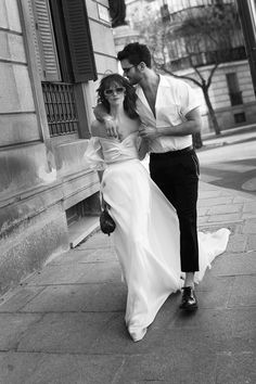 a man and woman walking down the street