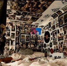 a bedroom with many pictures on the wall