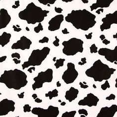 a black and white cow print fabric with spots on it's back side,