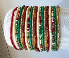 🦋 Discover the perfect Christmas beaded bracelet that doubles as a festive stocking stuffer gift and holiday party accessory. These elastic seed bead bracelets in red, green, and gold capture the spirit of Christmas, offering a stylish holiday stretch bracelet option for your seasonal celebrations. FESTIVE ELASTIC SEED BEAD BRACELETS: THE ULTIMATE HOLIDAY ACCESSORY  * Available in Christmas colors: red, green, gold, and cream, perfect for holiday-themed outfits and parties  * Offered individually or as a set, with five different sizes to suit various wrists  * Ideal for creating layered bracelet looks or wearing as standalone festive jewelry pieces  * Versatile for winter season wear, Christmas events, and thoughtful gifts for holiday enthusiasts  * Comfortable elastic design ensures easy Holiday Party Accessories, Homemade Bracelets, Layered Bracelet, Handmade Packaging, Christmas Events, Christmas Bead, Christmas Bracelet, Stocking Stuffer Gifts, Beaded Bracelets Diy