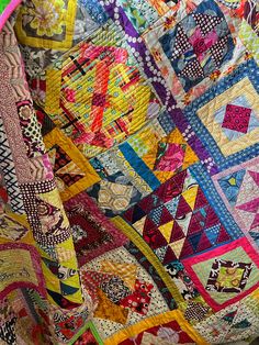 a close up of a colorful quilt on a chair