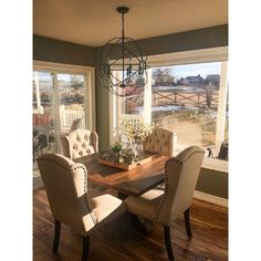 a dining room table with chairs and a chandelier