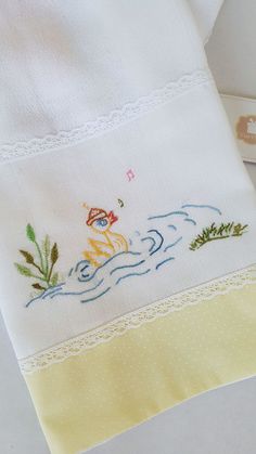 a close up of a towel with embroidered designs on it