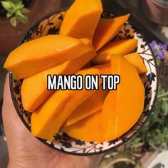 mango on top in a bowl with the words mango on it