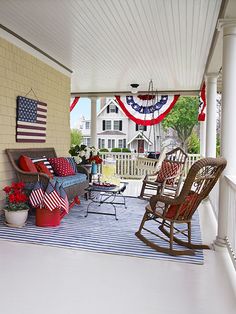 the porch is decorated with red, white and blue decor