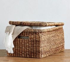 a woven basket sitting on top of a wooden table