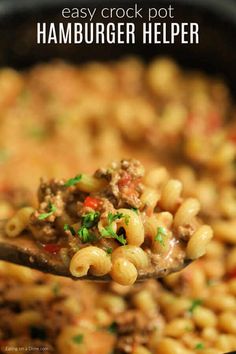 a spoon full of hamburger helper pasta in a skillet with the words easy crock pot hamburger helper