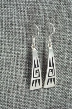 These sterling silver earrings were made by Hopi silversmith Augustine Mowa. The back is stamped sterling.Length: 1 1/2"Width: 3/8"Free shipping on all orders! We ship with USPS and always include tracking. All orders ship within a day of payment.Returns are accepted up to 30 days after you receive your order. Just send us a message. Our shop offers cash back or store credit. The item must be returned in new condition. Engraved Sterling Silver Dangle Earrings, Traditional Sterling Silver Engraved Earrings, Traditional Engraved Sterling Silver Earrings, Symbolic Hallmarked Sterling Silver Earrings, Native American Jewelry, Free Jewelry, Sterling Silver Earrings, Silver Earrings, Drop Earrings