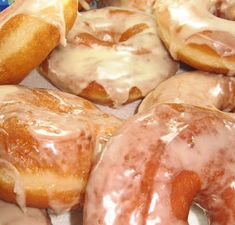 a box filled with lots of glazed donuts