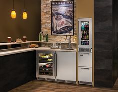 an image of a modern kitchen setting with refrigerator and wine cooler in the corner,