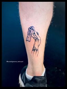 a person's foot with a tattoo on it that has an image of a woman holding