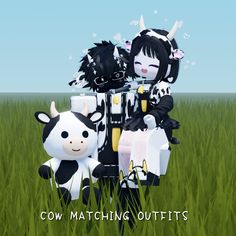 two dolls are sitting in the grass next to each other with cows on their backs