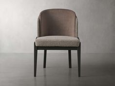 an upholstered chair with a beige seat and backrest, in front of a gray wall