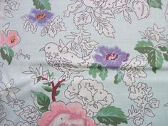 the fabric has flowers and birds on it