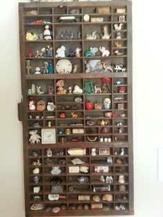 a wooden shelf filled with lots of figurines