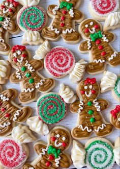 many decorated cookies on a table with candy canes and peppermink candies