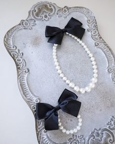 A classic pearl necklace and bracelet with a dainty satin bow definitely to add an effortless romantic and classic look to your formal or casual style. Perfect to complete your date night, wedding, bridesmaids, holiday party, and any special occasions. This necklace is elastic and consists of assorted sizes of pearls. The bow can be styled sideways or at the back, or turn it around for another way to wear it.  DETAILS: HANDMADE IMPORTED MATERIALS - We DO NOT offer refunds.  Selected items are eligible for EXCHANGE ONLY within 14 days of delivery date. All accessories are FINAL SALE.  - We are not responsible for lost or stolen items during transit. Additional insurance is available upon request. - Stay updated with latest news or promotion as we grow and follow us on the following outlets: Pearl Bow Necklace, Classic Pearl Necklace, Pearls Jewelry, Pearl Bow, Gift Flower, Night Wedding, Bow Necklace, Necklace Bridal, Flower Girl Gifts