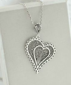 Introducing our Handcrafted Filigree Art Asymmetric Heart Figured Women's Silver Pendant Necklace! This stunning piece features a unique design with an asymmetric heart-shaped pendant, measuring 1.65 inches in height and 1.05 inches in width, suspended from a 20-inch silver chain. Expertly crafted with filigree art, this necklace is a beautiful addition to any jewelry collection. It comes with a silver polish cloth and a luxurious gift box, making it the perfect gift option for Mother's Day, ann Heart-shaped Metal Jewelry For Mother's Day, Double Heart Metal Jewelry Gift, Valentine's Day Open Heart Metal Jewelry, Nickel-free Double Heart Jewelry For Valentine's Day, Sterling Silver Heart Pendant Jewelry With Heart Beads, Sterling Silver Heart Pendant With Heart Beads, Heart-shaped Metal Necklace For Her, Double Heart Beads Necklaces For Jewelry Making, Open Heart Metal Jewelry For Wedding