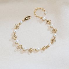 This dainty wire-wrapped pearl bracelet contains beautiful beads wire wrapped on a 14K gold-filled or sterling silver chain. This bracelet makes a great birthday or Christmas gift! Also available in anklet sizes! Measure your wrist or ankle to ensure the proper fit! There are four sizes available. The standard size bracelet has rosary chain of 6 inches with a 1.5 inch extension chain (7.5 inches total - fits wrists from 6 to 7.4 inches). The extended size bracelet has 7.5 inches of rosary chain Cheap Pearl Bracelet For Gifts, Handmade Delicate Pearl Bracelets, Delicate Handmade Pearl Bracelets, 14k Gold Filled Bracelet With Pearl Chain As Gift, 14k Gold Filled Pearl Chain Bracelet Gift, Handmade Delicate Pearl Bracelet, Elegant Gold Wire-wrapped Bracelet, Gold Pearl Jewelry Wire Wrapped, Dainty Handmade Pearl Bracelet