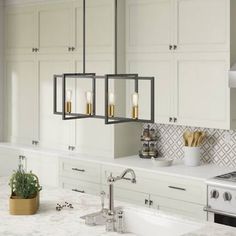 a kitchen with white counter tops and gold accents on the light fixture over the sink