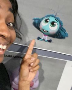 a woman pointing at a cartoon character with her finger in front of her face and the image of sul from inside out