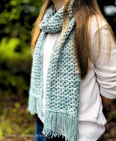 a woman wearing a blue crocheted scarf