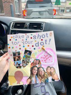 a person holding up a sign with photos on it in their car seat and the words take a shot for your dit