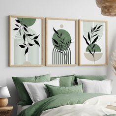 three framed art prints on the wall above a bed with green sheets and pillows in a bedroom