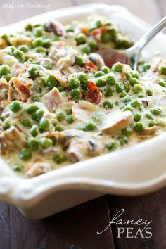 a casserole dish filled with peas and meat