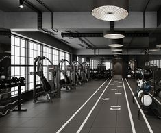 an empty gym with rows of exercise equipment