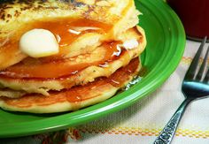 a stack of pancakes sitting on top of a green plate