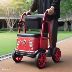 a man pushing a red and black toy bus