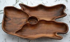 a wooden bowl sitting on top of snow covered ground