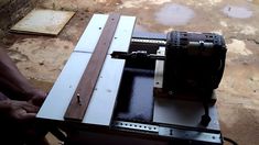 a machine that is sitting on top of a piece of wood in the process of being assembled