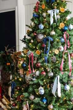 a christmas tree decorated with ornaments and ribbons