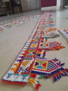 a long row of colorful beaded bracelets sitting on top of a floor