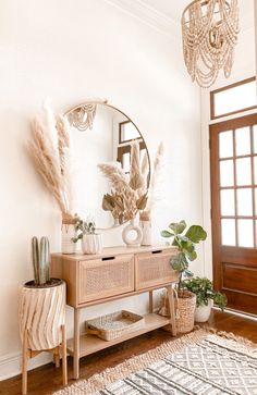 a living room with a mirror, table and plants