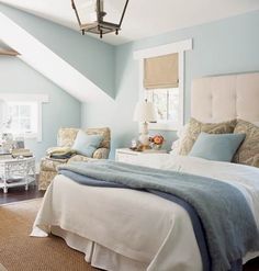 a bedroom with blue walls and white furniture