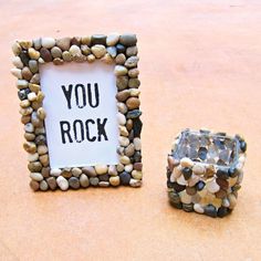 there is a rock frame next to a candle holder with a sign that says you rock