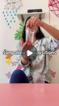 a woman sitting at a table with a cup in front of her and the caption song about repositionions